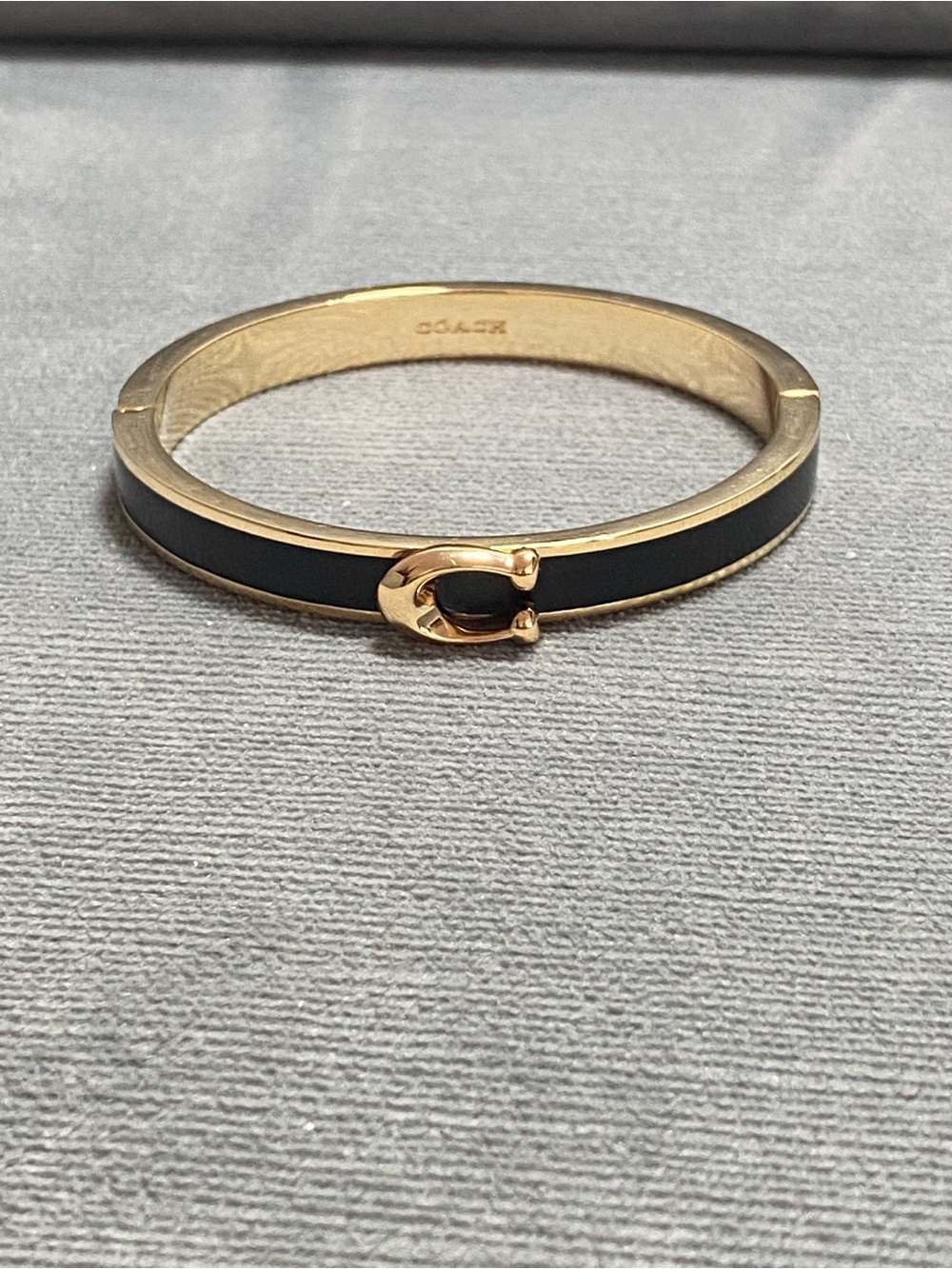 Coach Gold-Tone Bangle with Black Enamel and Horsebit Accent, magnetic closure